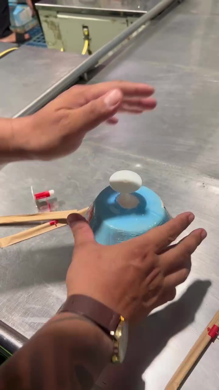 Model 2 fitted on a wrapped coconut at a packing station